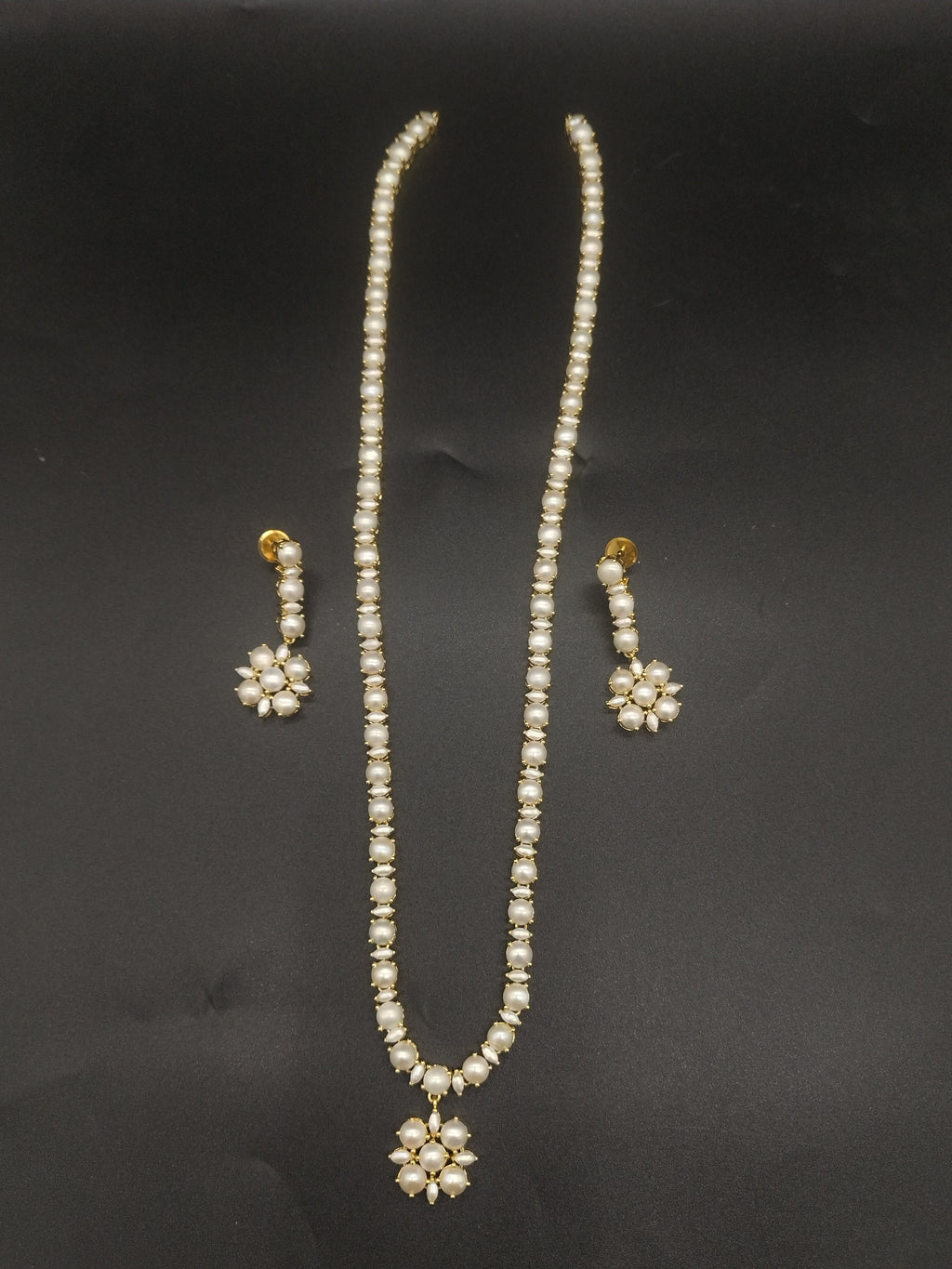 Single-line freshwater pearl long haram set with floral pearl centerpiece and matching drop earrings.