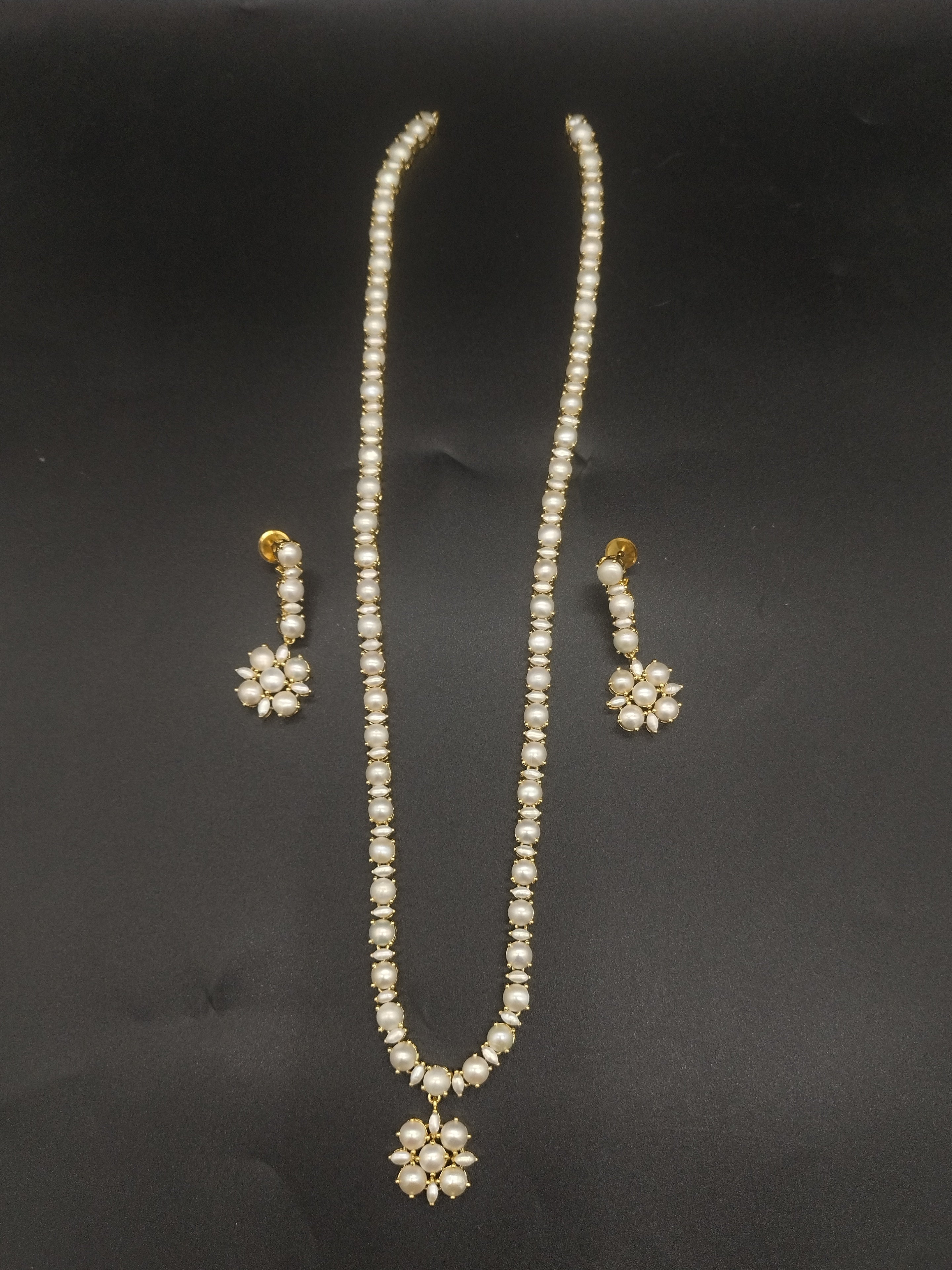 Single-line freshwater pearl long haram set with floral pearl centerpiece and matching drop earrings.