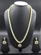 Single-line freshwater pearl long haram set with green stone floral centerpiece and matching drop earrings.