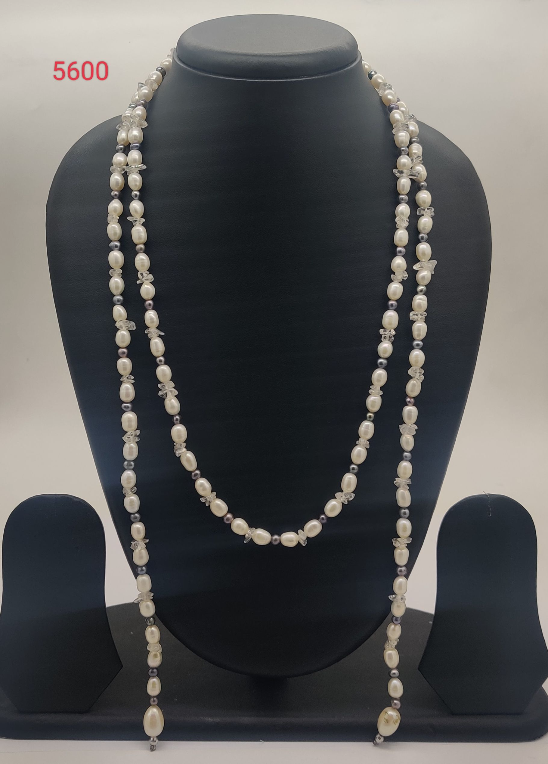 Snowfall Twilight Drape freshwater pearl necklace with white oval pearls grey round pearls and crystal accents in cascading multi strand design