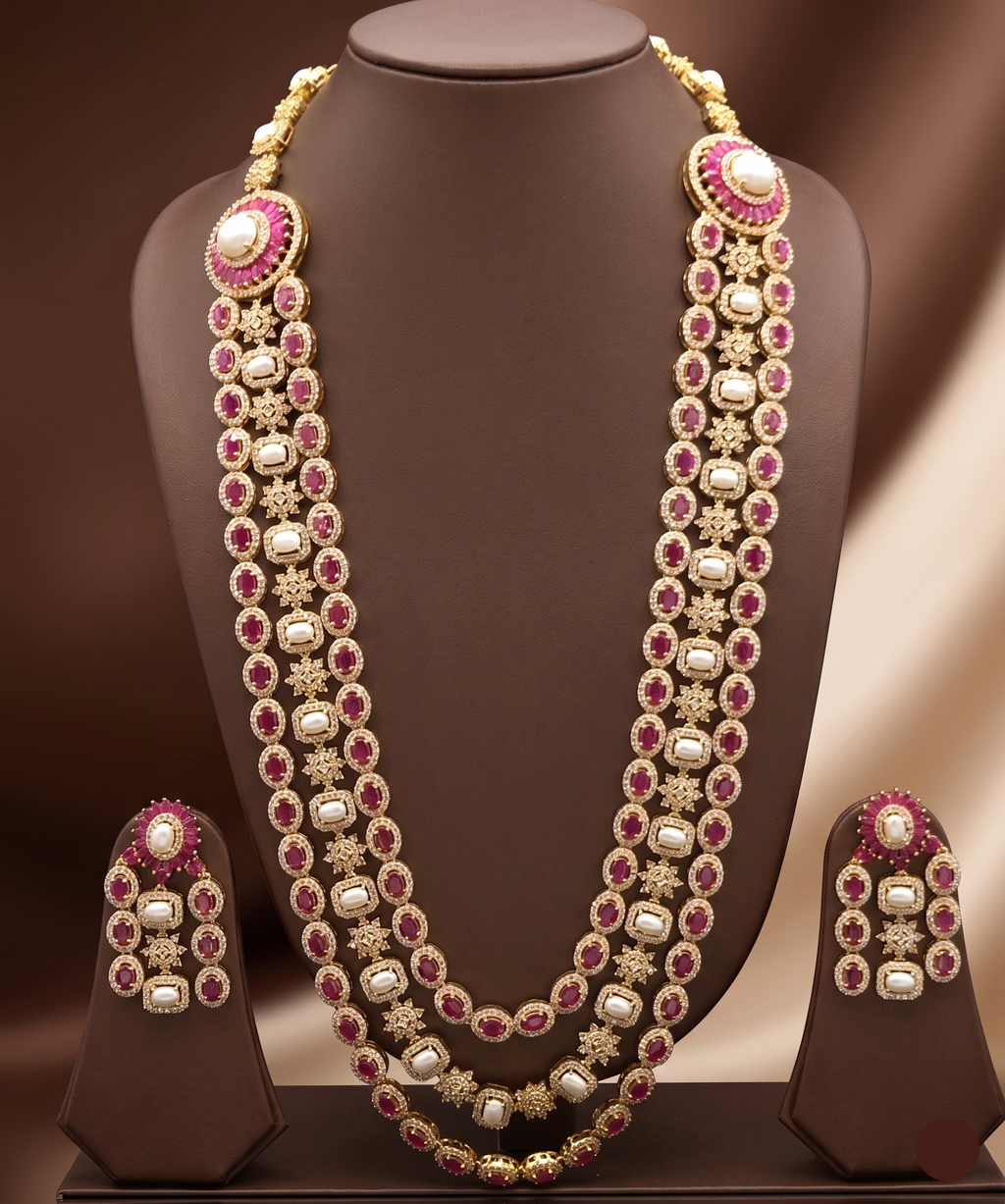 Three-line freshwater pearl long haram set with red and white stone detailing and matching statement earrings.