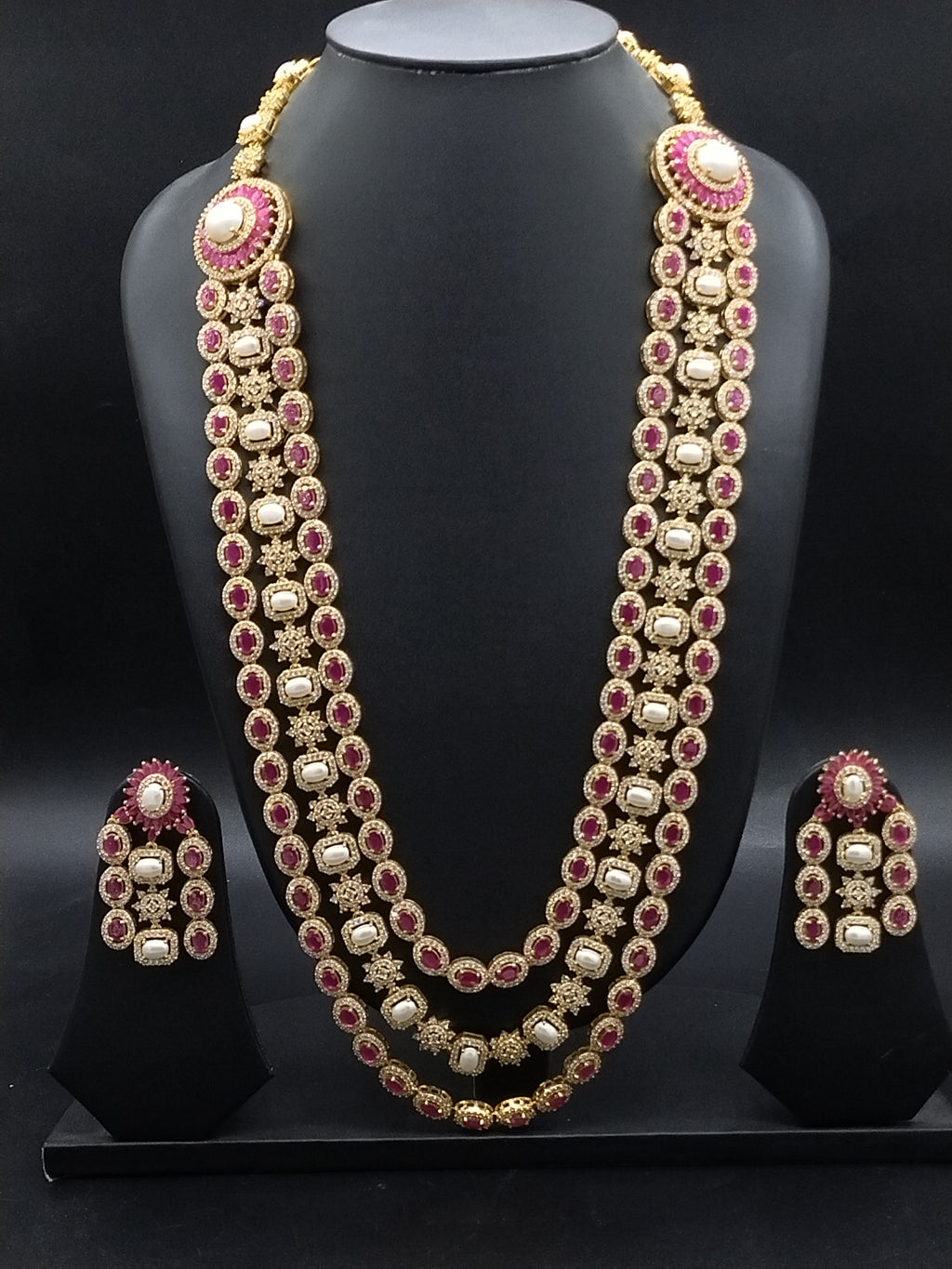 Three-line freshwater pearl long haram set with red and white stone detailing and matching statement earrings.