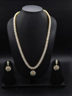 Three-line freshwater pearl long haram set with sunburst floral pendant and matching floral earrings.