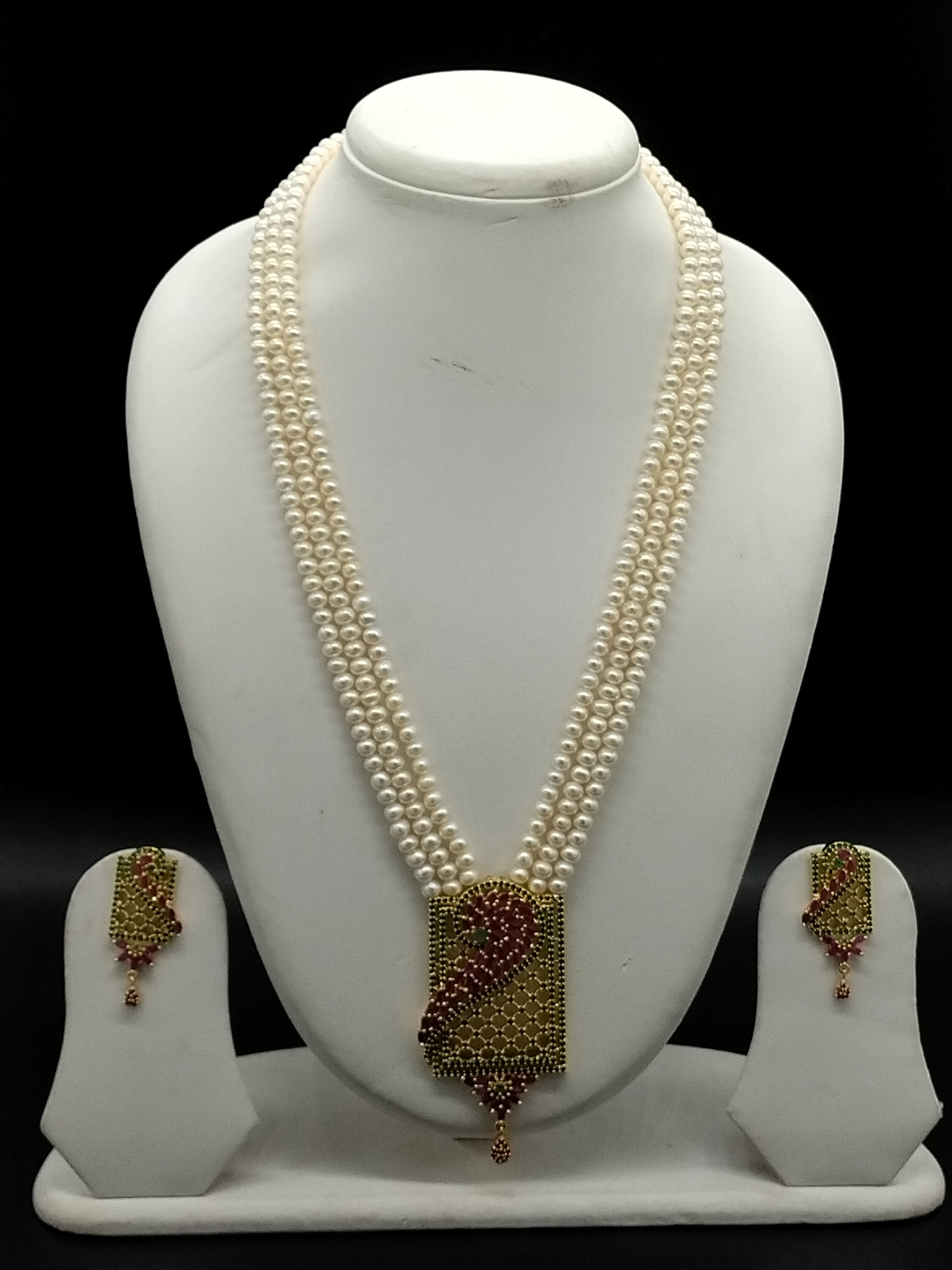 Three-line white freshwater pearl Rani Haar necklace set with red and green stone detailing and matching earrings