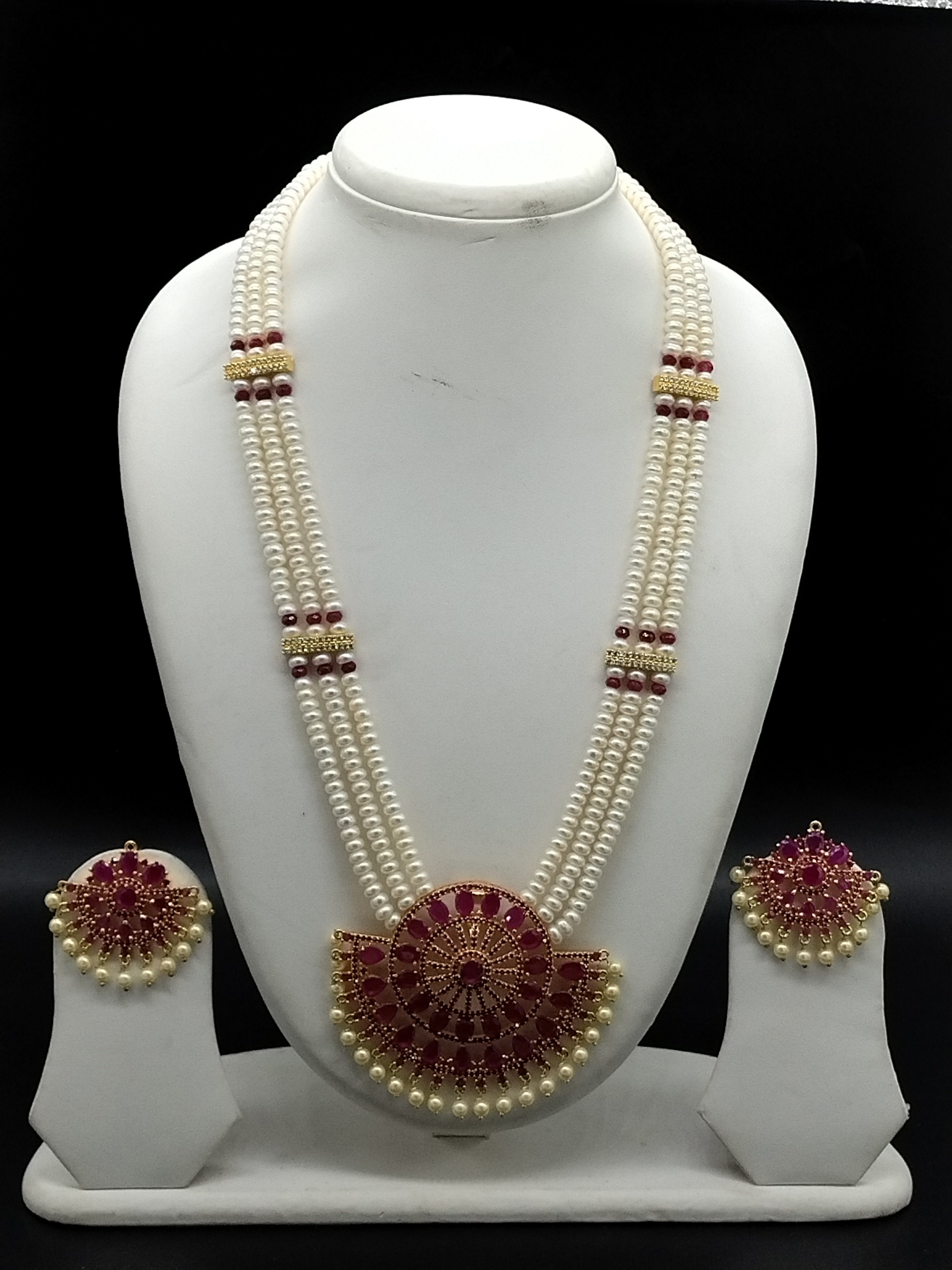 Three-line white freshwater pearl Rani Haar necklace set with red stone centerpiece and matching earrings