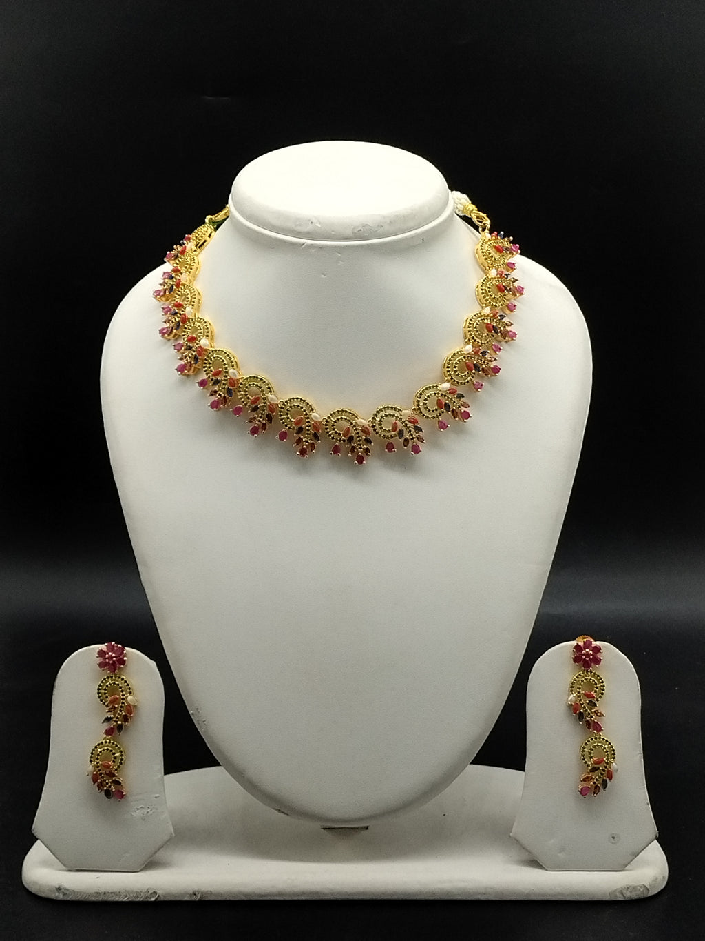 Traditional temple necklace set with red and green stones, floral and mango motifs, and matching drop earrings.