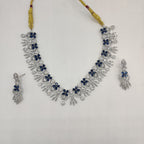White and royal blue American Diamond collar necklace set with matching drop earrings.