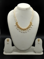White freshwater pearl pendant necklace set with two line oval pearls and kundan style gold centerpiece