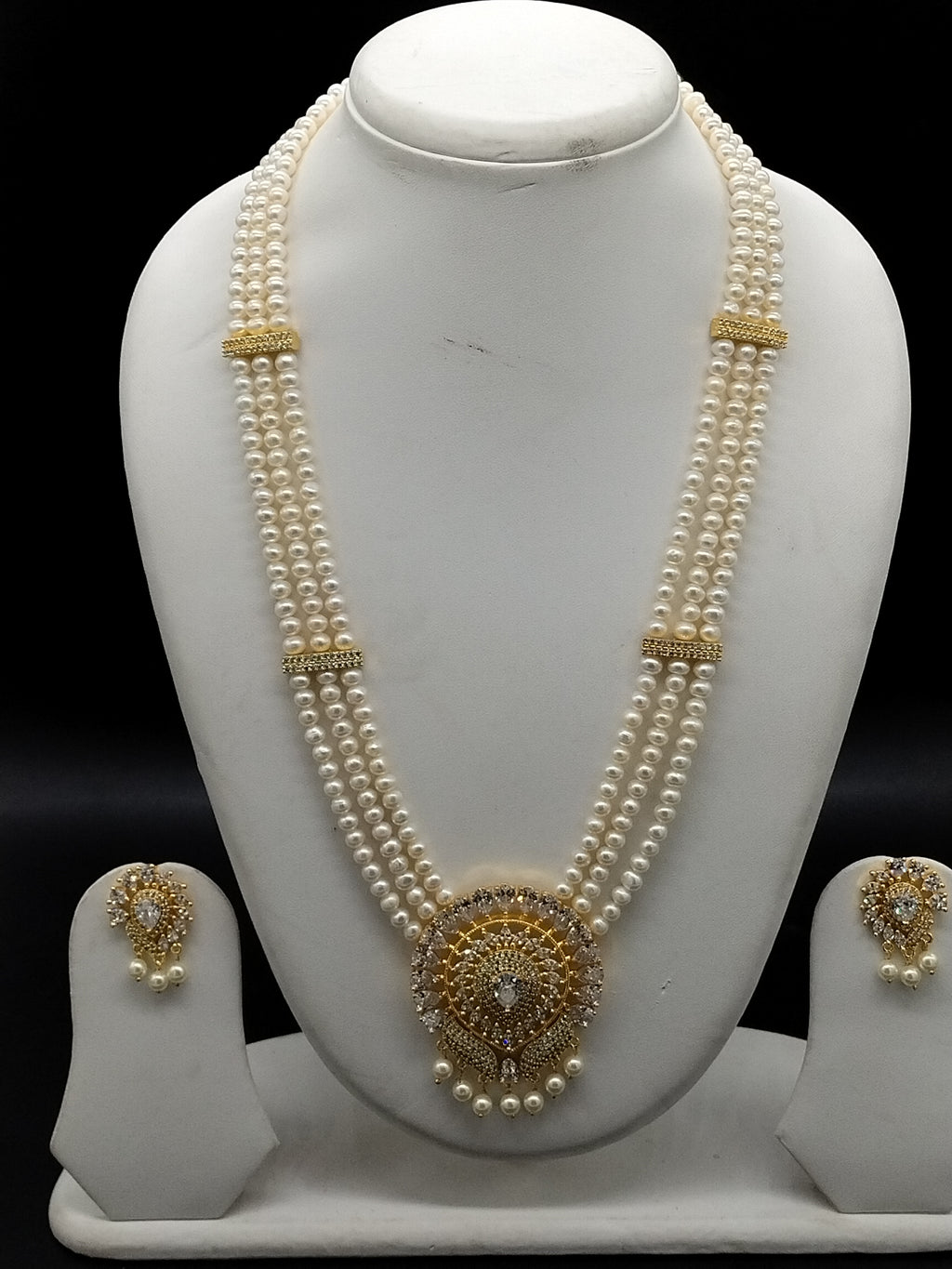 White freshwater pearl Rani Haar necklace set with ornate circular pendant and matching earrings