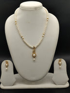 White freshwater pearl pendant necklace set with flat pearls and gold pendant with matching earrings