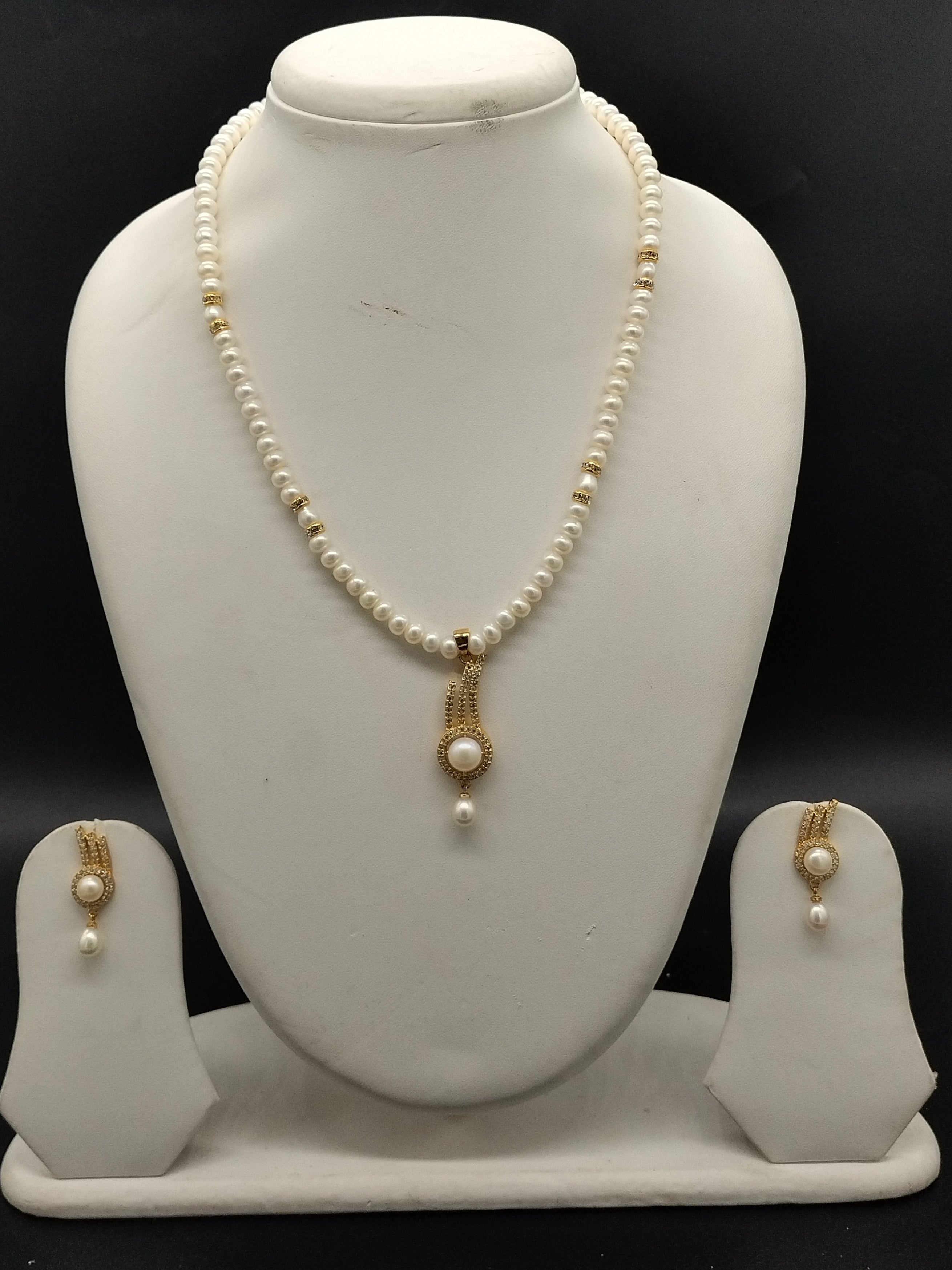 White freshwater pearl pendant necklace set with flat pearls and gold pendant with matching earrings