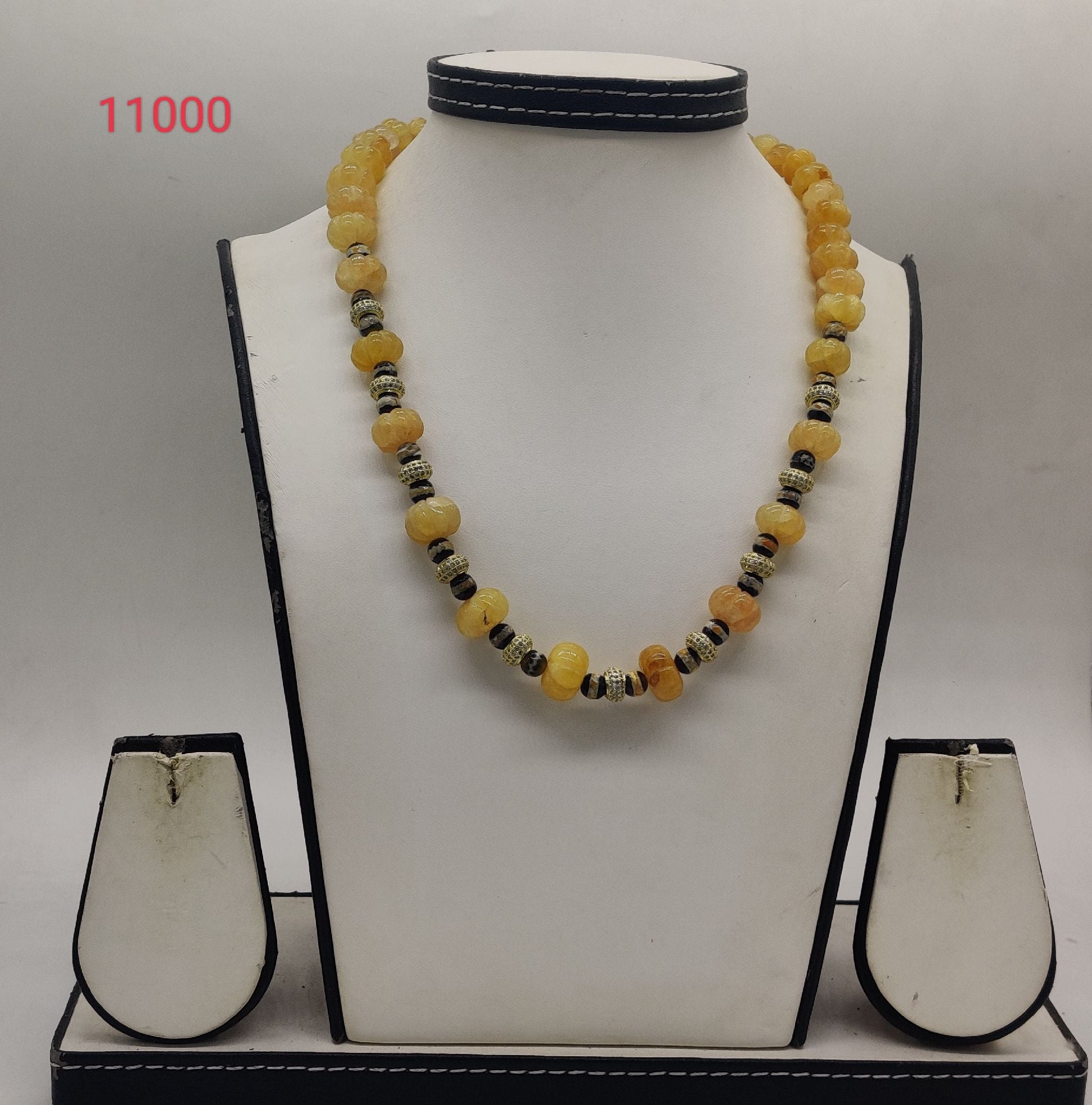amber beaded necklace with pumpkin yellow beads and silver spacers in symmetrical design