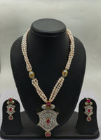 four line freshwater pearl pendant necklace set with peach oval pearls and ornate shield pendant