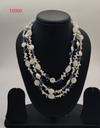 freshwater pearl necklace with blue beads and clear carved accents in multi layer design