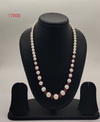 freshwater pearl necklace with graduated white pearls and red bead accents in single strand design