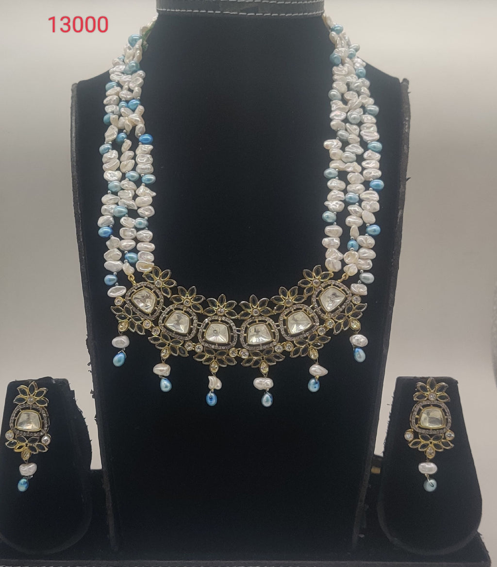 freshwater pearl polki pendant set with white and blue pearls and floral design with matching earrings