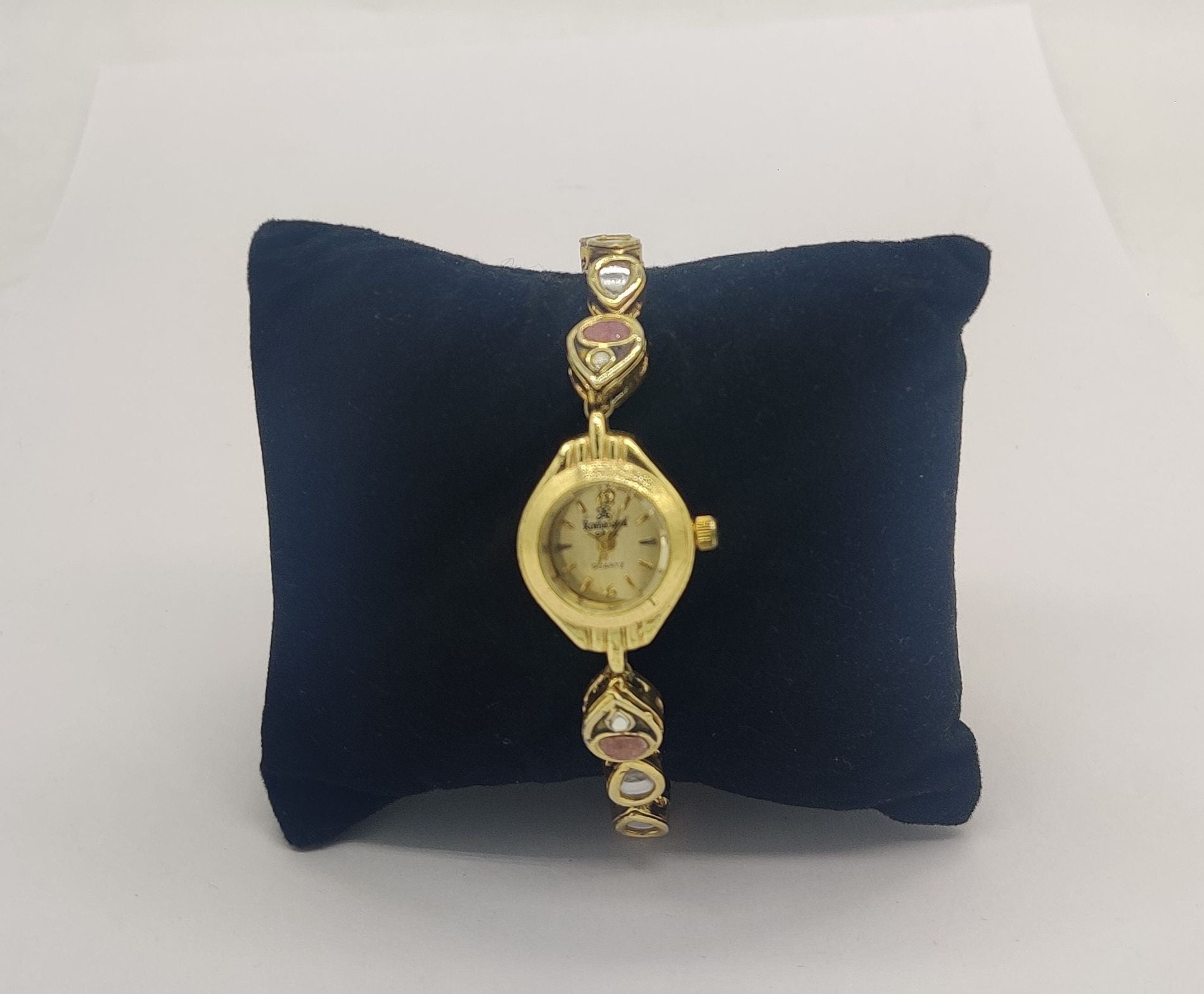 gold tone designer bracelet watch for women with pink stone accents