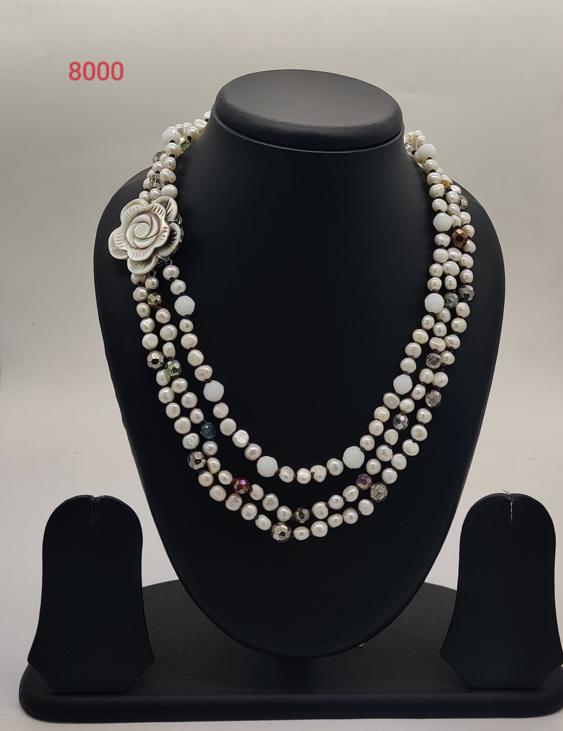 multi strand freshwater pearl necklace with crystal accents and floral clasp design