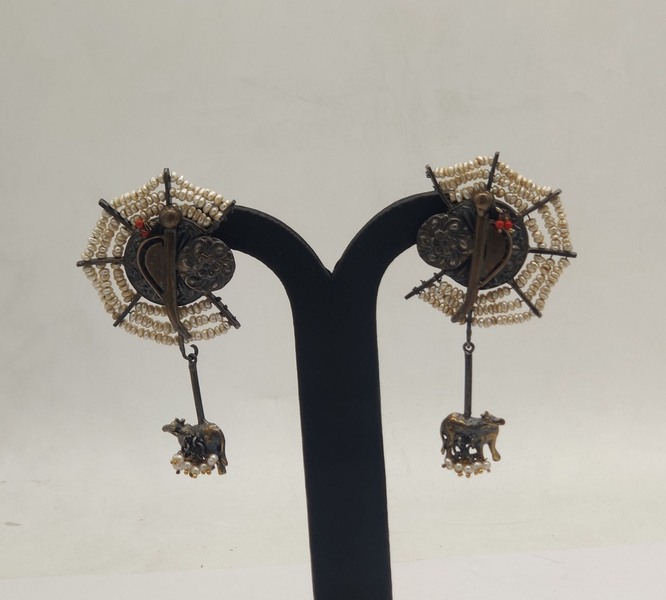 sacred bull temple oxidized silver earrings with pearl clusters and red stone accents