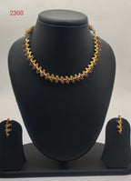 traditional gold tone temple necklace set with red stone design and matching earrings