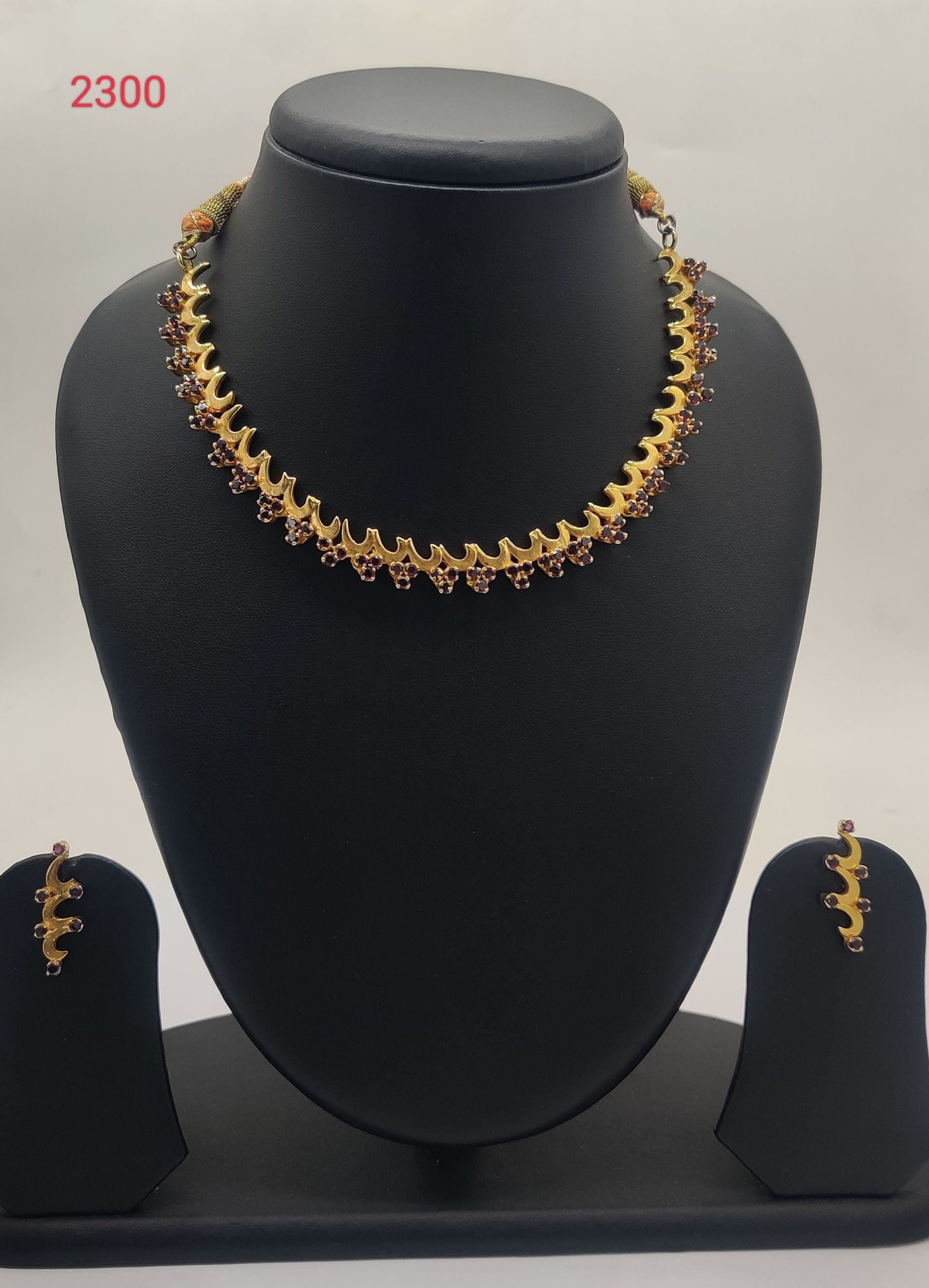 traditional gold tone temple necklace set with red stone design and matching earrings