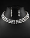 white freshwater pearl choker necklace and earrings set with oval pearls and elongated drop earrings