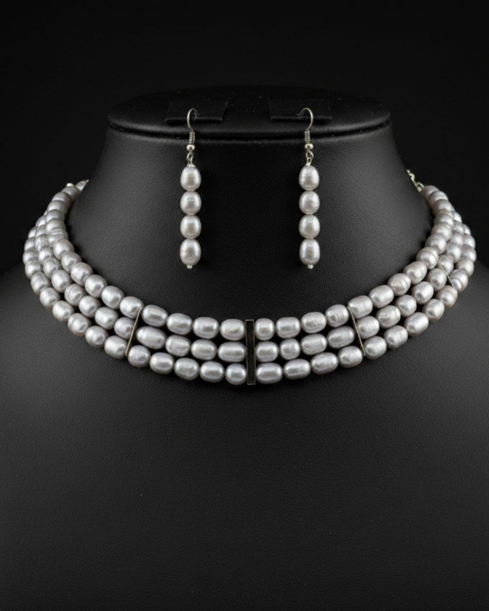 white freshwater pearl choker necklace and earrings set with oval pearls and elongated drop earrings